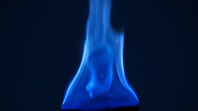 Blue flame burning in darkness.