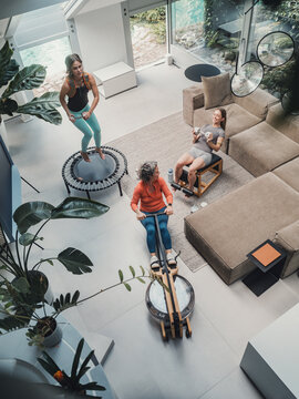 Family exercising together in living room with fitness equipment