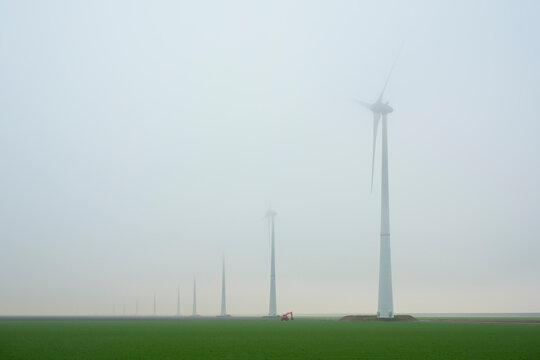 Wind turbines in foggy landscape at Eemshaven the Netherlands