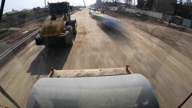 Cab view from road roller compactor working on highway, timelapse
