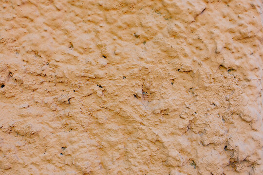 Rough orange plaster wall texture close up background