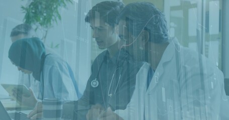 Reviewing data team in hijab scrubs labcoat at ward with tablet laptop stethoscope data overlay © vectorfusionart