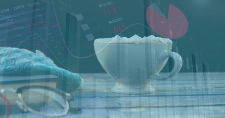 White cup sitting on painted wooden slats, frothy latte, glasses and teal knit, charts overlaying