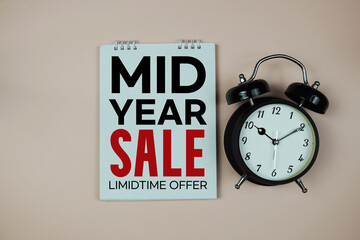 Mid Year Sale text with alarm clock on pink background