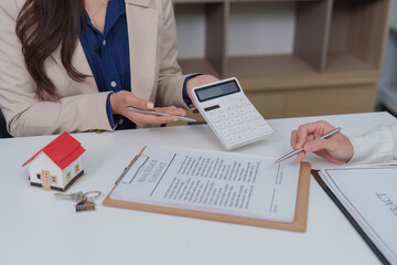 Real Estate Consultation. Agent using calculator to discuss property finances.