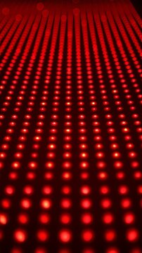 Red light therapy with depth effect and red light pattern glowing rows create vibrant dynamic abstract background, 4k video.
