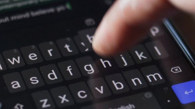 Typing message on smartphone keyboard, close up. sending text message using mobile phone. press touch screen keyboard keys. smart phone, dark mode display. texting online. web communication. send sms