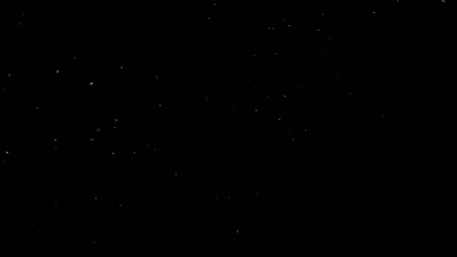 Abstract dark background with small white dots and particles.