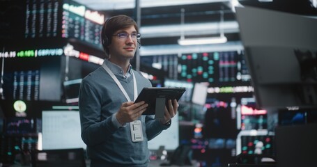 Successful Financial Analyst Surveying Real Time Trading Floor. Young Trader Stands in of High Tech...