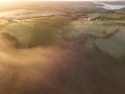 Hills countryside sunrise in morning fog - Arial drone view