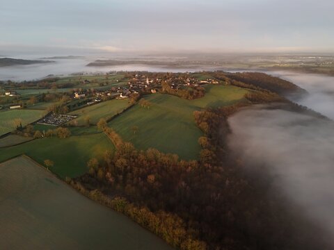 French village countryside sunrise in morning fog - Arial drone view