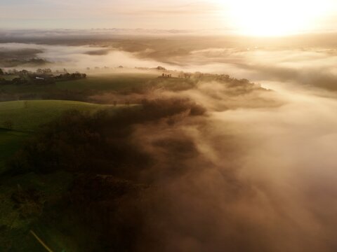 Hills countryside sunrise in morning fog - Arial drone view