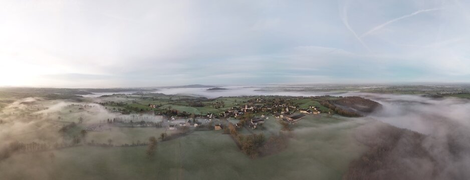 French village countryside sunrise in morning fog - Arial drone view
