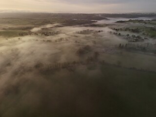 Fototapeta premium Hills countryside sunrise in morning fog - Arial drone view