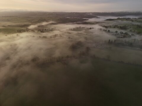 Hills countryside sunrise in morning fog - Arial drone view