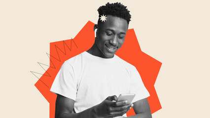 A young man smiles as he looks at his smartphone. He is wearing wireless earphones. The background...