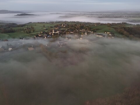 French village countryside sunrise in morning fog - Arial drone view