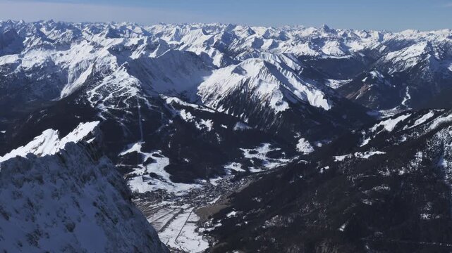 Snowy alpine mountains with Lermoos village in the valley under clear winter skies