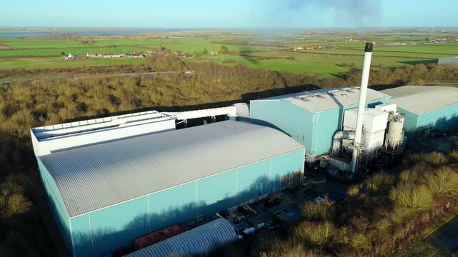 Aerial drone view of the Elean Biomass Power Station near Ely, UK, large straw-fired power plant, showing its massive straw storage barns.