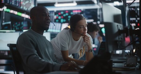 Female Financial Supervisor Mentoring Male Analyst at Stock Exchange Station. Professional Woman Providing Expert Guidance as Analyze Complex Market Data Together. Knowledge Sharing in Brokerage Firm.