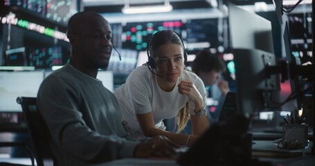 Female Financial Supervisor Mentoring Male Analyst at Stock Exchange Station. Professional Woman Providing Expert Guidance as Analyze Complex Market Data Together. Knowledge Sharing in Brokerage Firm.