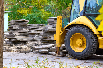 Demolition.Excavator bulldozer hydraulic stops loads old concrete slabs © Igor