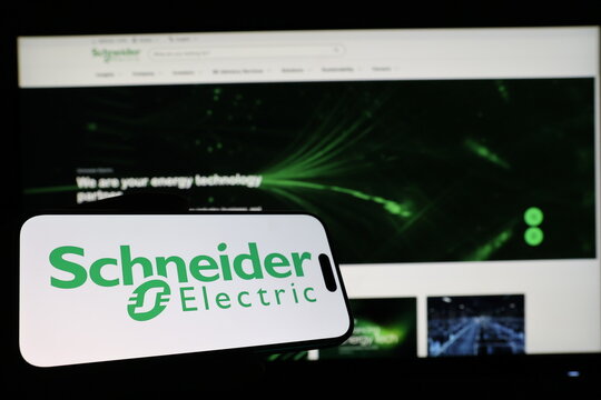 Kiel, Germany - 03-12-2026: Smartphone displaying French electrical equipment company Schneider Electric logo in front of companys webpage