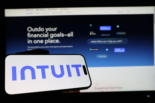 Kiel, Germany - 03-12-2026: Smartphone displaying US financial software company Intuit logo in front of companys webpage