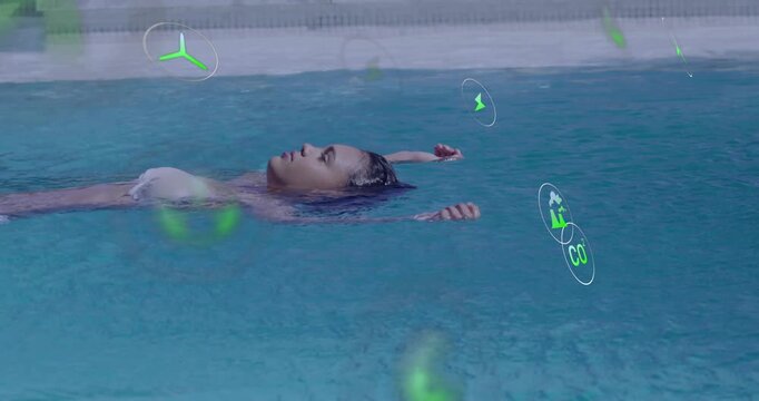 Floating female wearing white bikini top in pool by deck, with green graphic icons drifting