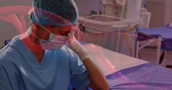 Female clinician taking pre-surgery pause in OR, clasping gloved hands, DNA helix overlaying hands