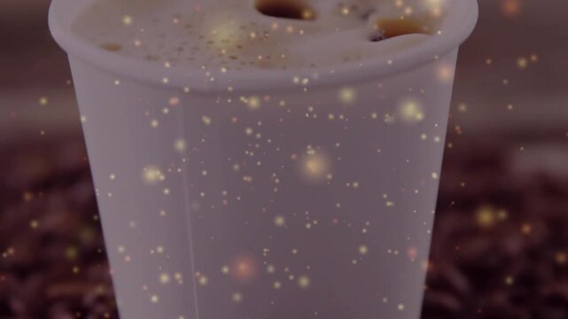 Camera pulling back showing coffee cup, gold glow drifting, foam settling, beans at base for promo