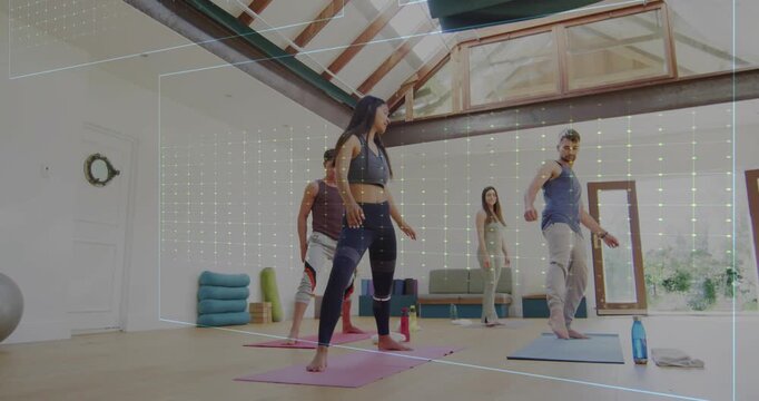 Leading instructor in dark sportswear guiding group through lateral steps in loft, showing hologram