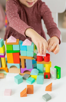 A child plays with wooden blocks. Selective focus.