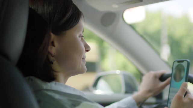 Woman Video Chatting Using Cellphone While Driving. Distracted Driving Scene