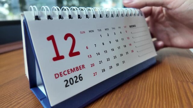 Slow motion footage of flip calendar pages for change months from november to december of the year 2026. concept of planning and starting a new month. 4k horizontal.