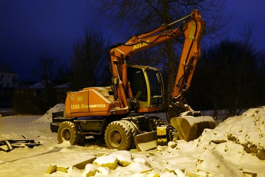 Kielce, Świętokrzyskie, Poland - February, 16-2026: Work at night. Excavator on building: Atlas 1305 M AWE 5 System.