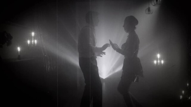 1920s old style black and white color silhouette romantic happy couple dancing enjoying time together in dark night club. woman flapper with man have fun at dance floor retro party, roaring twenties.