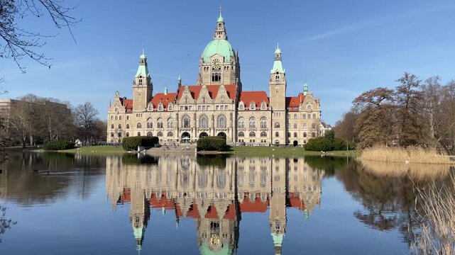 Neues Rathaus or New Town Hall in Hannover Germany with reflection in pond Maschteich on a sunny day in winter