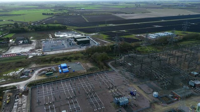Cinematic drone footage of the Walpole electrical substation, showcasing the vast expanse of transformers, switchgear, and power infrastructure.