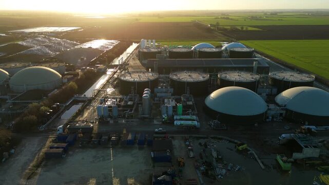 High-altitude aerial shot of an anaerobic digestion facility, highlighting the geometric layout of storage domes and energy infrastructure.