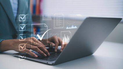 Business professional typing on laptop managing digital checklist and document workflow with data dashboard interface for task organization, business analysis and productivity management system