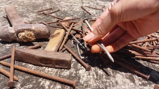 footage of many old rusty nails showing corrosion and decay caused by the oxidation process. 