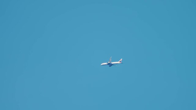 Cargo transportation expanding across global air routes at high altitude. Freight airplane flying through clear blue sky supporting international logistics. Civil aviation connecting markets