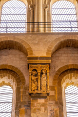 Naklejka premium Romanesque stone carving depicting Mary and angel Gabriel inside Conques Abbey