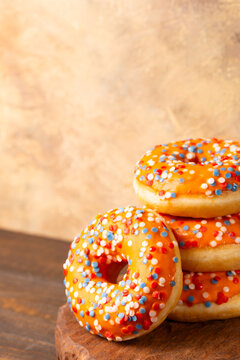 Glazed orange donats and tompouce dessert with Dutch event Kings day in background. National holiday Koningsdag on 27 April in the Netherlands. Holland culture concept with copy space