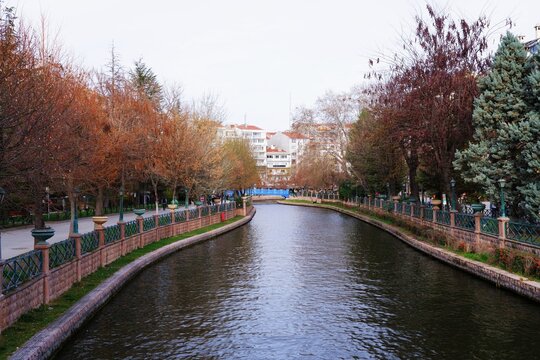 Canal flowing through a city park in autumn