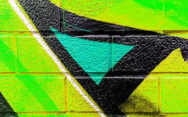 Art under ground. Beautiful street art graffiti background. The brick wall is decorated with abstract drawings house paint. Modern style urban culture of street youth. Abstract picture on wall © Yaroslav