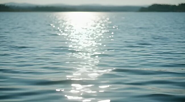 Sunlight dancing on the water creates sparkling reflections across a serene lake