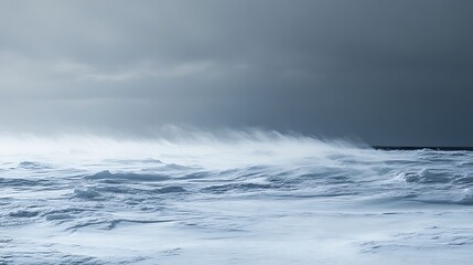 Obraz premium Dramatic winter landscape snow covered ground under a stormy sky