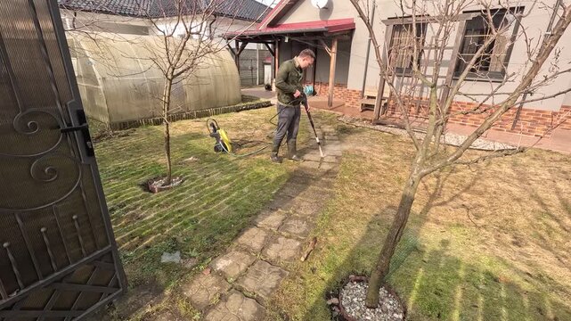 Cleaning tiles with a pressure washer. Timelapse video of removing mold and grime from tiles using high-pressure water. Spring gardening.